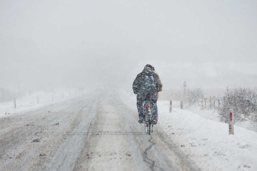 man cyklar i snömodd
